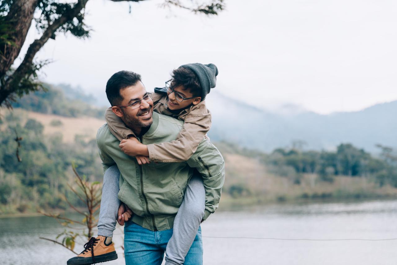Father carrying son on his back