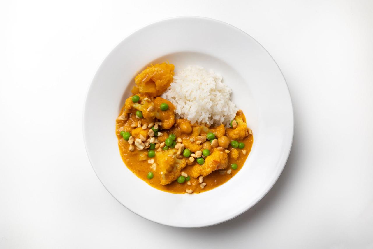 Chickpea, Cauliflower and Coconut Curry served over rice on a plate