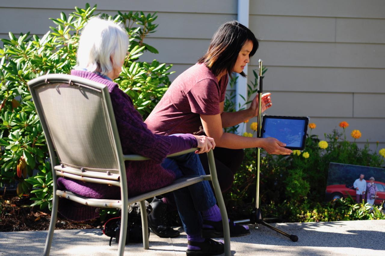 Elderly woman being assisted with a health-care worker