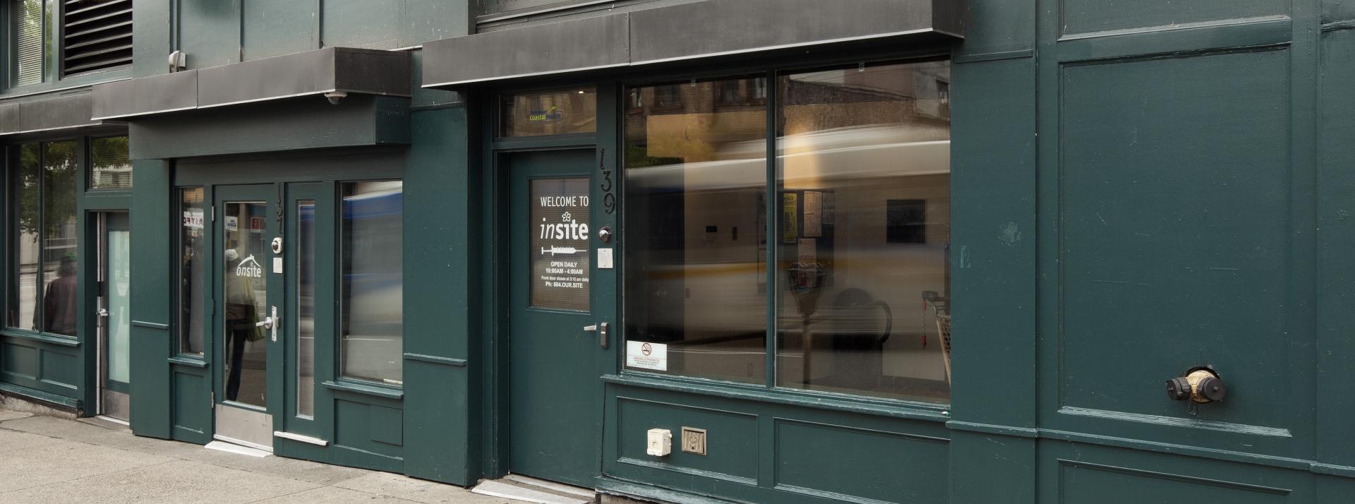 The exterior of Insite. A sign on the door reading welcome to insite is visible