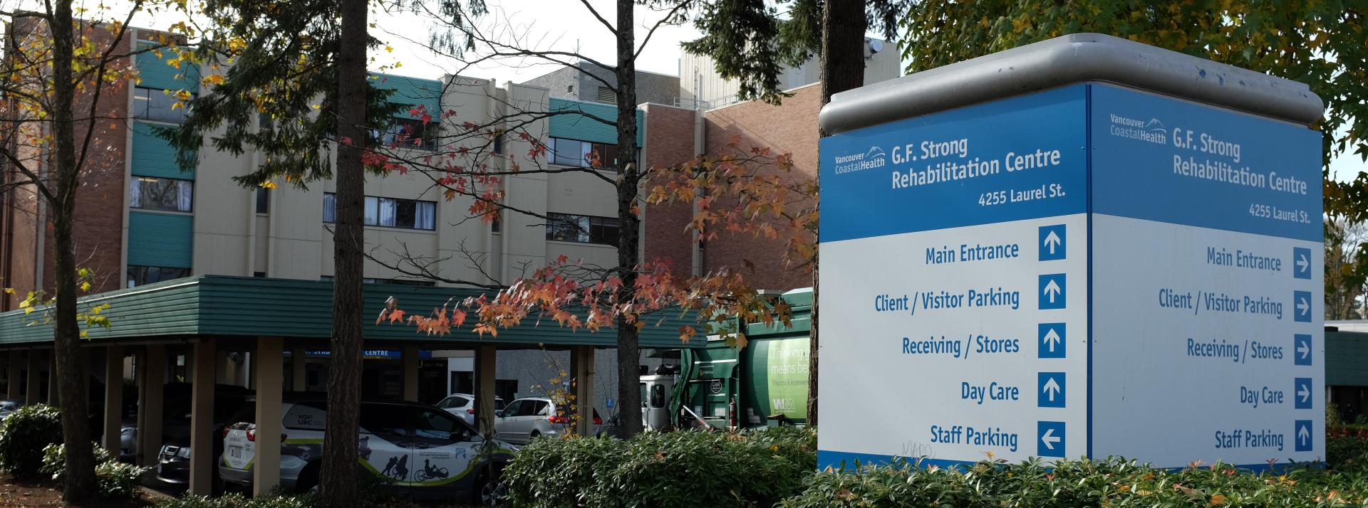 Exterior of G.F. Strong Rehabilitation Centre with wayfinding sign in the foreground