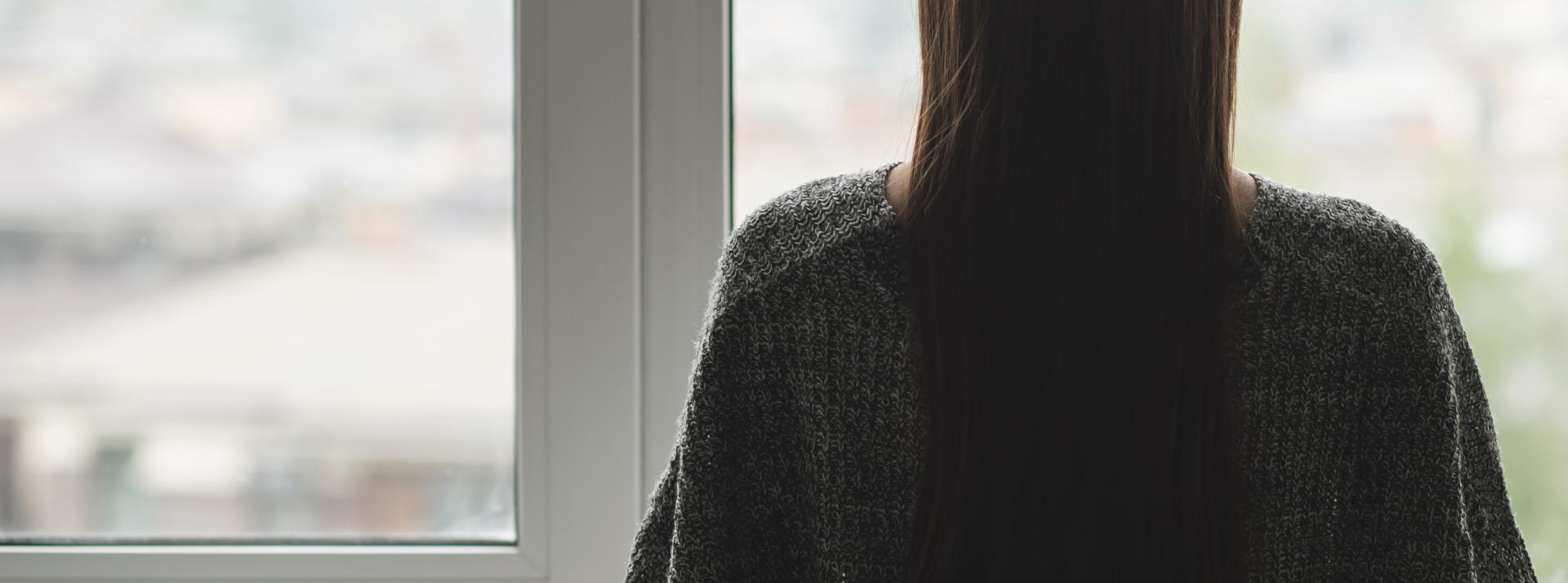 woman looking out window