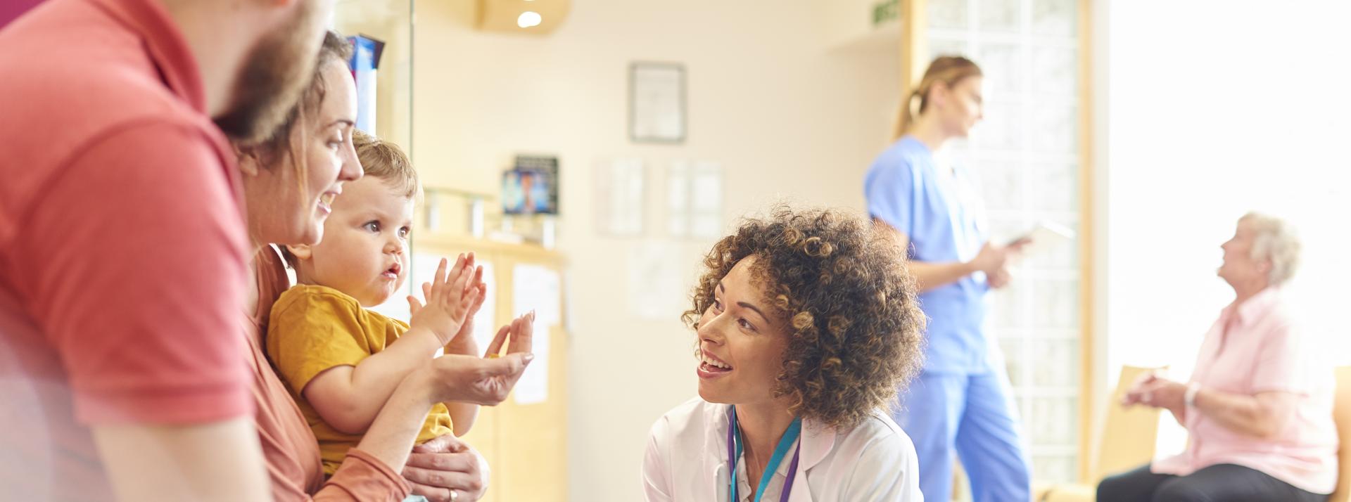 Female doctor talking to toddler 