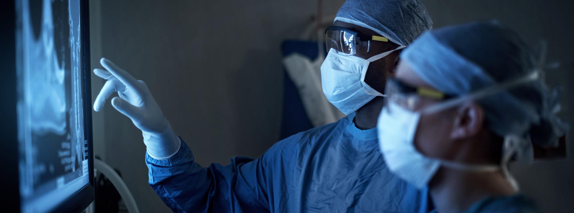 Shot of two surgeons analyzing a patient’s medical scans during surgery
