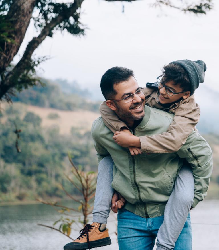 Father carrying son on his back