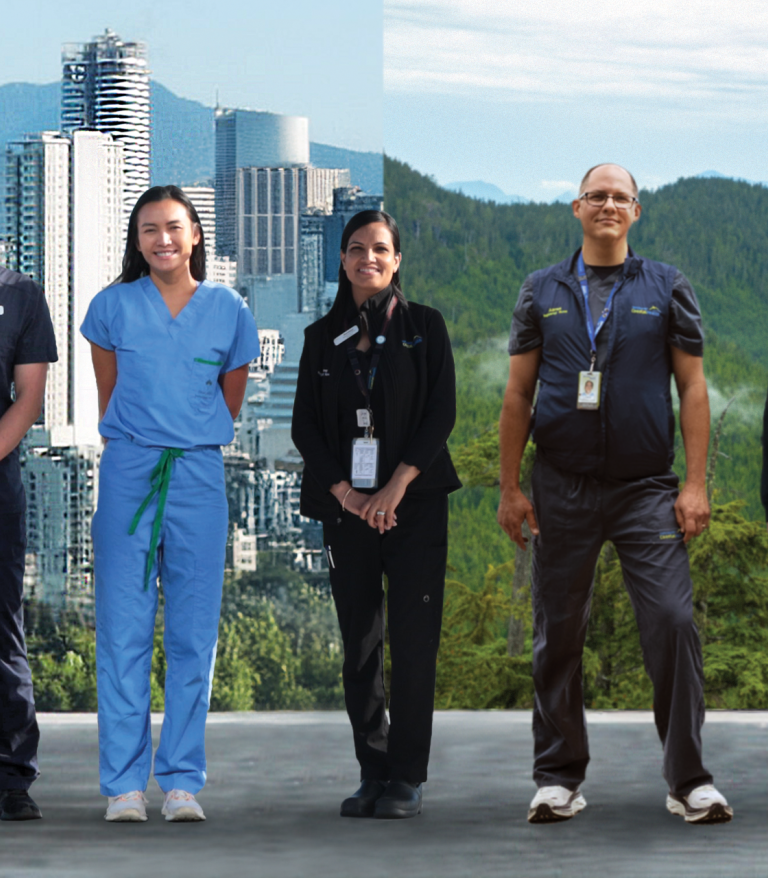 Staff standing against backdrop of city and mountains