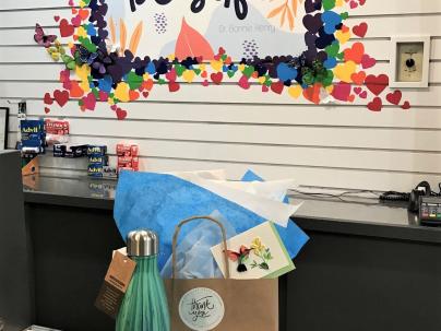 A gift bag and waterbottle on a counter inside the Vancouver General Hospital gift shop.