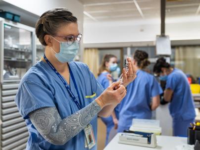 Nurse with needle in intensive care unit