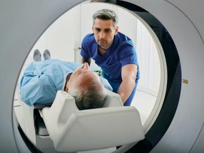 An MRI technician helping a patient with a scan