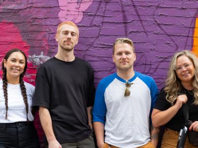Mental health and substance use team photo in front of a mural