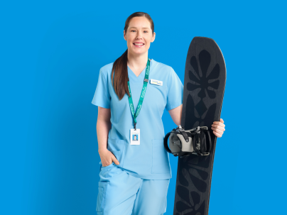 Photo of Siobhan, Registered Nurse, holding a snowboard against a blue background